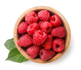 Raspberries in a wooden plate and leaves on a white background. Top view