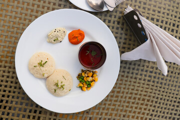 Classic South Indian breakfast. soft idlis served with coconut chutney and flavorful sambar. Idli...