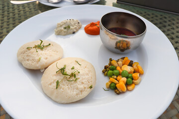 Classic South Indian breakfast. soft idlis served with coconut chutney and flavorful sambar. Idli...