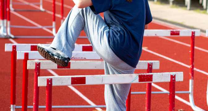 Runner Warming Up to Race Over Hurdles before a race