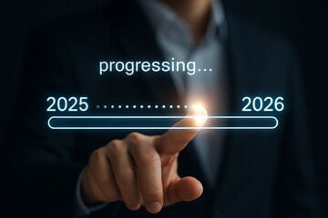 Progress bar from 2025 to 2026 being advanced by a finger in a dark background with suit jacket