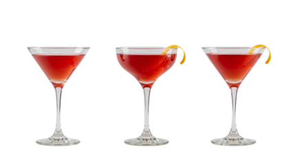 Elegant presentation of three ruby red cocktails with citrus zest on a transparent spread