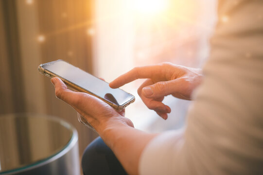 Hand holding smart phone in Social media marketing concept. hand using smartphone typing, chatting conversation in chat box icons pop up