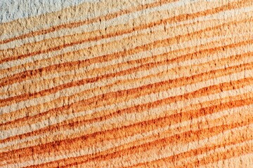 Close-up of layered, diagonal, light orange and tan lines