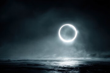A luminous ring floats above a misty shoreline at night