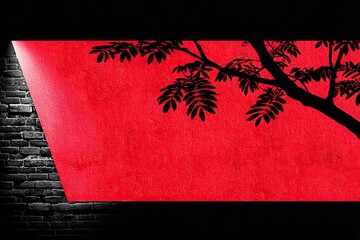 Red backdrop with tree silhouette against dark brick wall, illuminated by spotlight