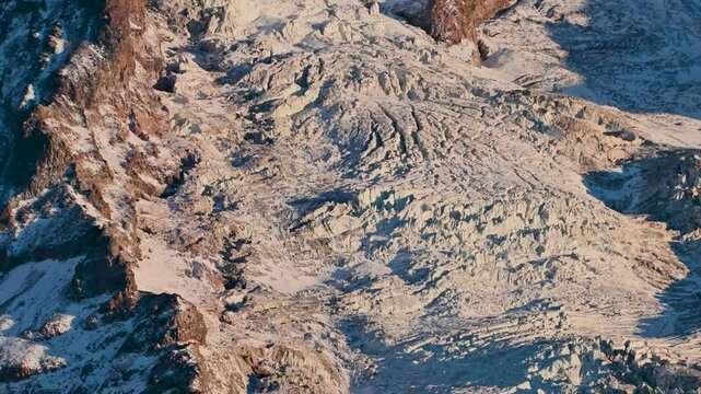 Mount Rainier glaciers, rugged, snow-covered slopes and ridges in dramatic winter light.
