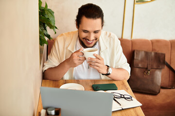 Young man enjoys coffee while working remotely in a vibrant cafe during summer