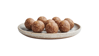 A plate filled with dark, round chocolate energy balls, speckled with light bits, offering a healthy treat png