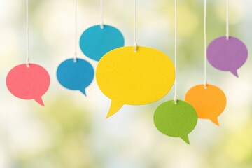 Colorful Speech Bubbles Hanging Lightly Symbolize Dialogue, Communication, and Modern Connection Against a Soft Focus Background.