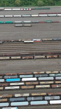 Railway infrastructure aerial view revealing dense network of parallel tracks with multiple freight cars, displaying logistical complexity and industrial transportation scale