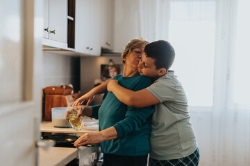 A touching moment of an elderly woman cooking while being embraced lovingly by a young boy, symbolizing warmth, care, and family bonding.