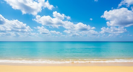 Fototapeta premium Vibrant blue sky with fluffy white clouds over a tropical turquoise ocean