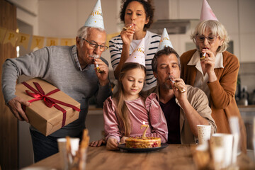 Family Celebrating a Birthday Together With Cake and Gifts