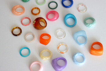 Collection of colorful plastic rings on white background. Selective focus.