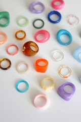 Collection of colorful plastic rings on white background. Selective focus.