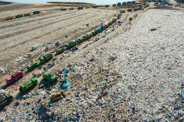 Drone image shows landfill site with excavator working among mixed waste, symbolizing global...
