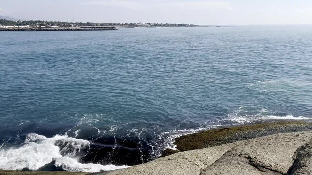 Wide-angle close-up capturing movement of coastal sea water.