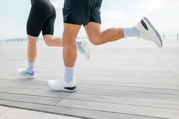Morning joggers enjoying a scenic run along a waterfront promenade