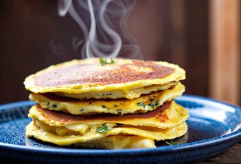 Close-up of a stacked omelet in a blue ceramic dish with rustic morning setting