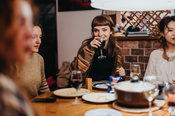 A group of friends gathers around a dinner table, enjoying wine and conversation in a warm and inviting setting. The atmosphere radiates joy, connection, and an intimate sense of friendship.