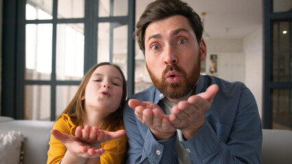 Funny positive Caucasian lovely family man father dad sending air kiss little kid schoolgirl...