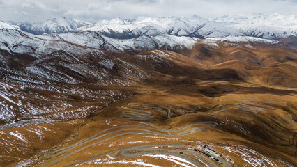 Aerial view of the winding road leading to Mount Everest from the Tibetan side, surrounded by...