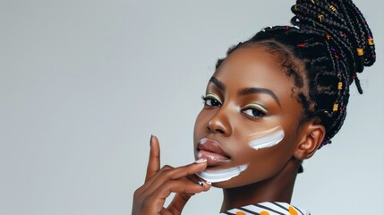 Beauty and skin care. Skincare hydration and oil balance. Portrait of African American woman with afro braids hairstyle is applying a cream smear on her face and standing against white background