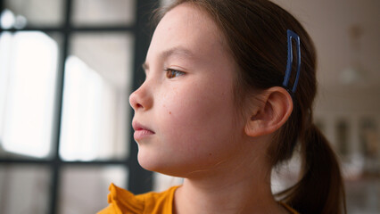 Close up disappointed little Caucasian child girl getting upset frustrated at home. Sad daughter...