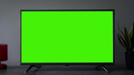 TV screen mockup background. Lcd tv monitor with blank green screen in living room while watching - Powered by Adobe