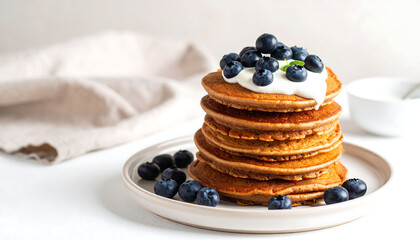 Delicious gluten-free buckwheat pancakes served on ceramic plate with blueberries