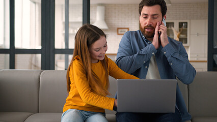 Mischievous Caucasian little girl daughter kid interfering dad from remote freelance job angry...