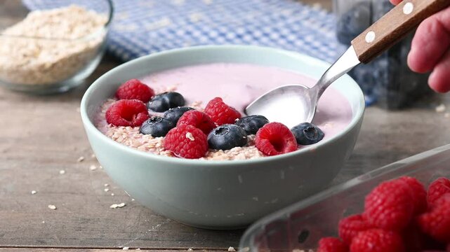 Eating healthy smoothie bowl with berries