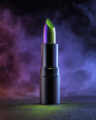 Vibrant lipstick with unique green and purple hue stands tall against smoky, colorful background, creating eye catching and artistic display. glowing colors evoke sense of creativity and boldness