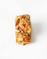 Bar of nuts, cereals and honey on white background. Healthy food. Isolated