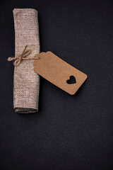 Rustic kraft paper tag with heart cutout on black background