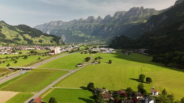 Scenic Aerial View of a Valley with Green Fields and Mountain Landscape in Switzerland near Flums, Berschis, and Walenstadt in the Canton of St. Gallen &ndash; Drone Footage