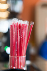 Many red colored tubules in glass jar. Close up