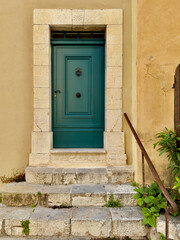 Charming French home entrance  with stone steps, dark green wooden door. Ideal for: architecture photography, Provence travel inspiration, real estate, and lifestyle visuals.