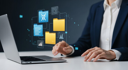 A person in a suit interacts with a laptop, accessing digital files and icons.