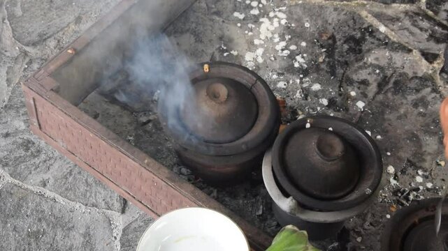 Closeup of a man's hands cooking Serabi Indonesian food
