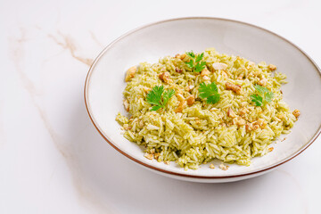 Exquisite green rice dish garnished with herbs and nuts for a delightful meal