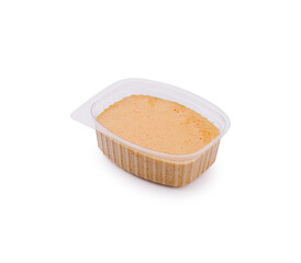 Peanut butter in a plastic container ready for spreading on bread