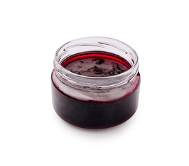 Homemade berry jam in a glass jar ready for spreading on fresh bread