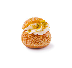 Delicious cream puff dessert topped with whipped cream and pistachios in focus