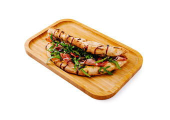 Grilled sandwich with fresh greens and meat served on a wooden tray