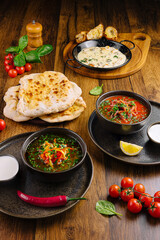 Flavorful curry feast with naan, side dishes, and fresh ingredients
