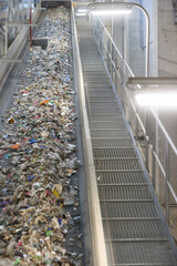 RDF fuel production line with municipal waste on a conveyor belt in Waste-to-Energy plant. Ideal for: recycling, sustainable energy, waste management, environmental protection.