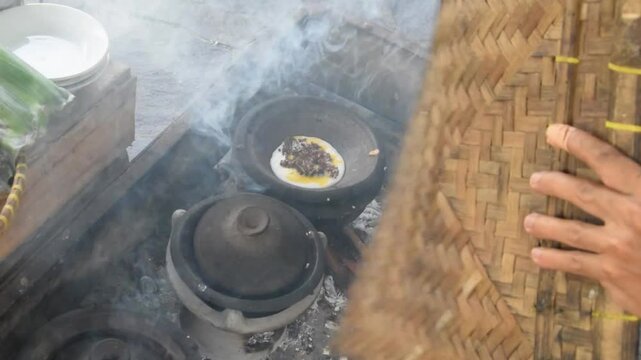 Closeup of a man's hands cooking traditional Indonesian Serabi