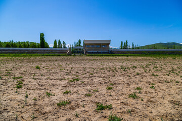 Serene Kok-Boru stadium in rural setting under mountains